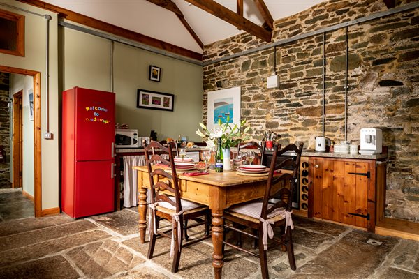 Kitchen with dining table in a family farm holiday cottage