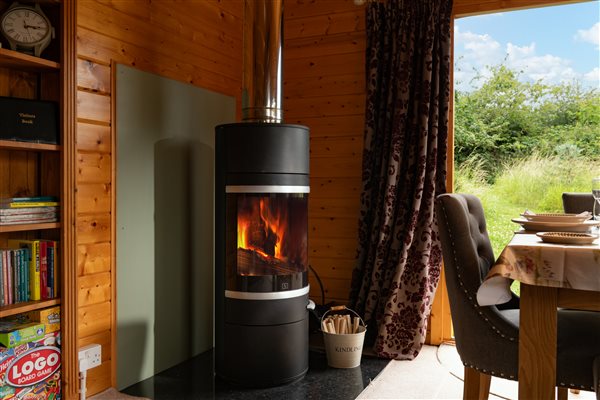 Log burner with view into garden through double doors