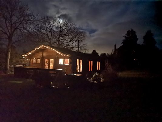 cosy log cabin with exterior fairy lights