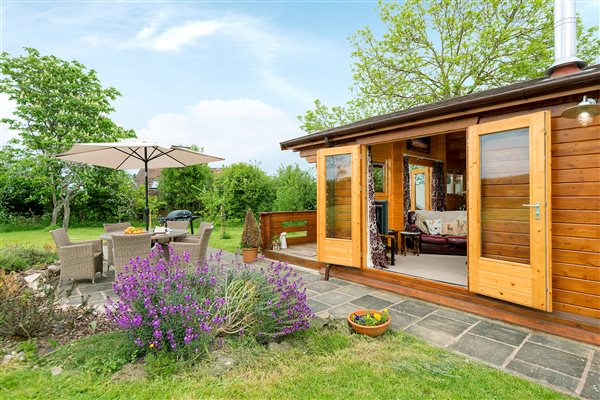 French doors to terrace with bbq and rattan seating