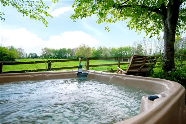 Soak in the hot tub overlooking the paddock