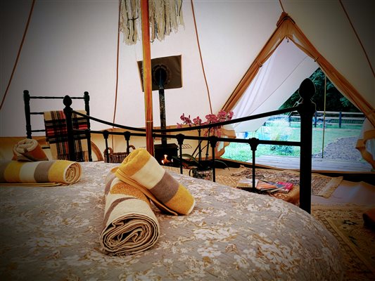 kingsize bed inside providing a luxurious glamping experience 