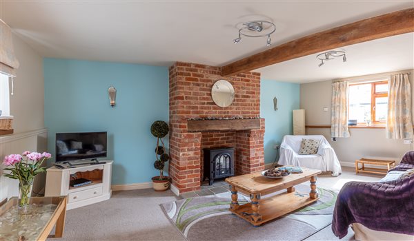 The Old Dairy sitting room with electric wood burner