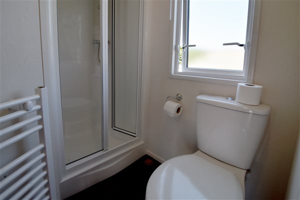Bathroom with shower and heated towel rail