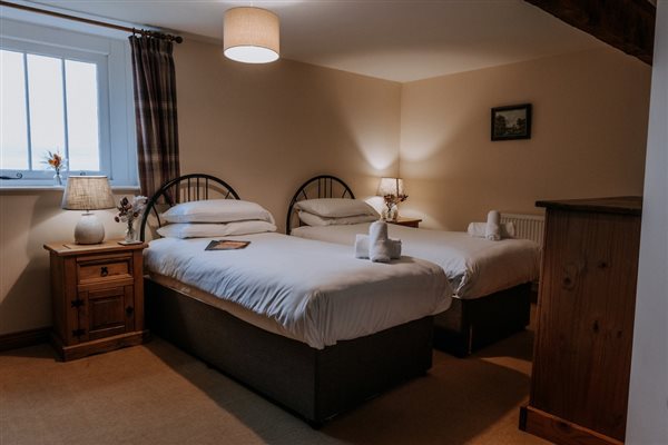 A bedroom in one of the cottages at Mocketts Farm Holiday Cottages in Kent. 