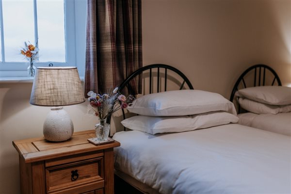 A bedroom in one of the cottages at Mocketts Farm self-catering complex in Kent. 