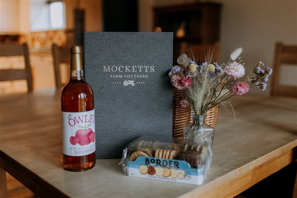 A welcome pack with juice and biscuits at self-catering cottages at Mocketts Farm in Kent.