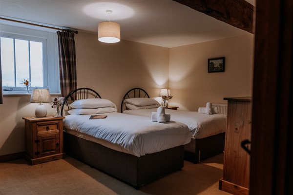 A bedroom at self-catering cottages at Mocketts Farm in Kent. 