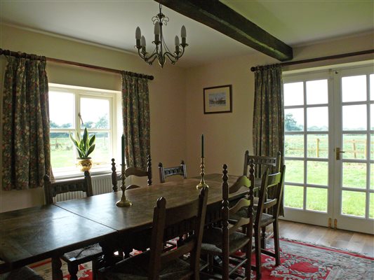 Dining room with wooden beams.