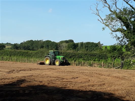 dressing the ground for re-seeding at Llwyn Beuno - llynholidays.wales