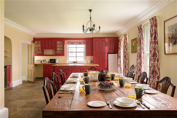 Kitchen with a reclaimed teak dining table that seats 14