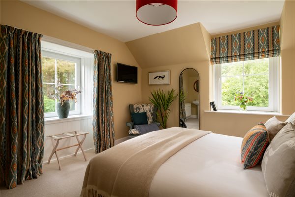 Double bedroom with king sized bed (5ft) and basin. Shower room opposite.
