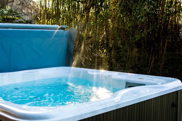 Relaxing in the hot tub at Glynn Barton Cottages