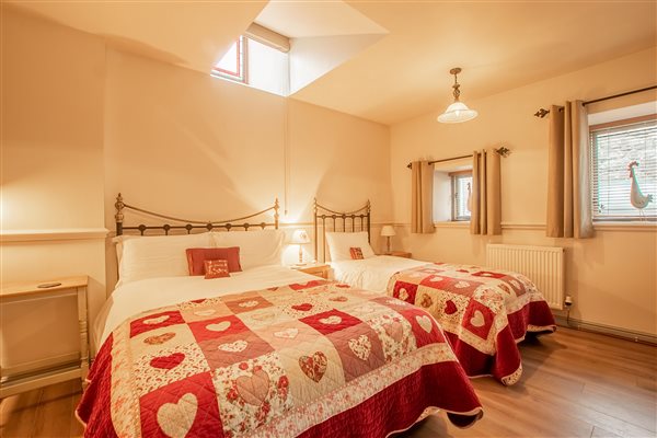 Bedroom at Y Stabal suite number 2 at Snowdonia Holidays Tyddyn du Farm, dog friendly cottages in Eryri close to beaches, zip world, llechwedd and hiking and best mountain biking in Wales. UK