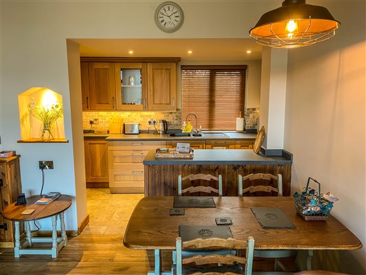 Dining area and kitchen at Ty Gwair 5 - Luxury hay barn conversion with mountain views in Tyddyn Du Farm Eryri