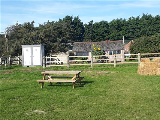 Summer view of the site with picnic bench