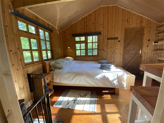 Queen size bed with views over the lake