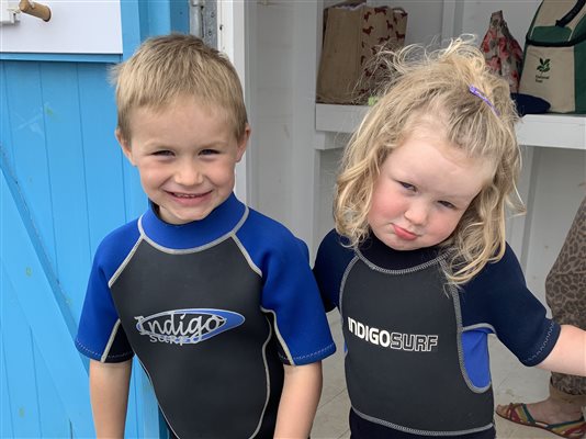 Boy and girl in wetsuits