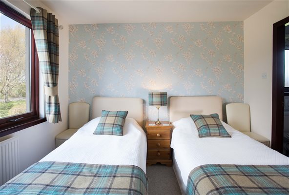 Twin bedded en-suite room with bath and shower over bath Twin bedded en-suite room with bath and shower over bath