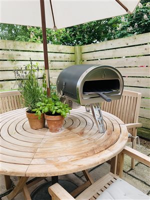 Patio area with seating and pizza oven
