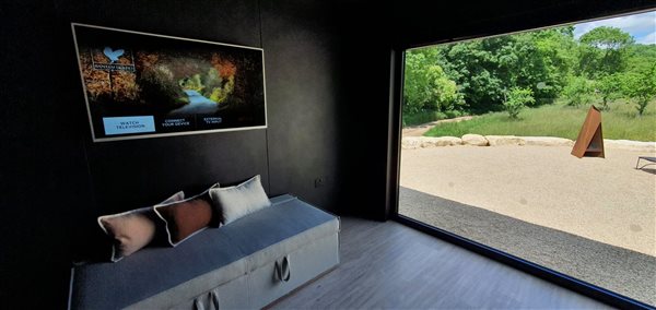 The living room and it's picture window immerse you in nature. Further distraction is provided by the generous television, compatible with Chromecast and Netflix.