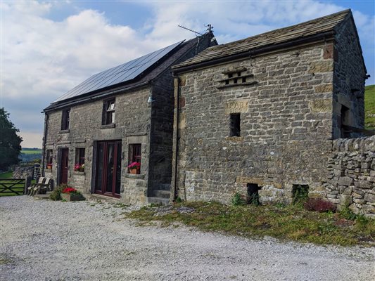 Coach house stands next to quaint old stone dovecote